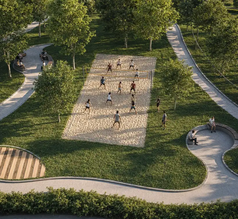 Sand volleyball court among trees and walking paths